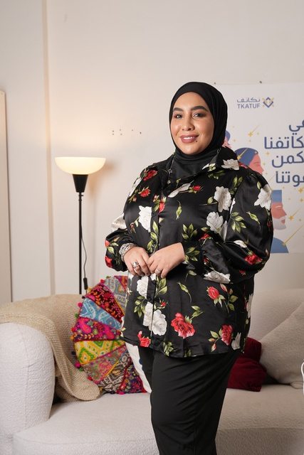 A guest in a floral gown at a fashion opening managed by Limitless Power