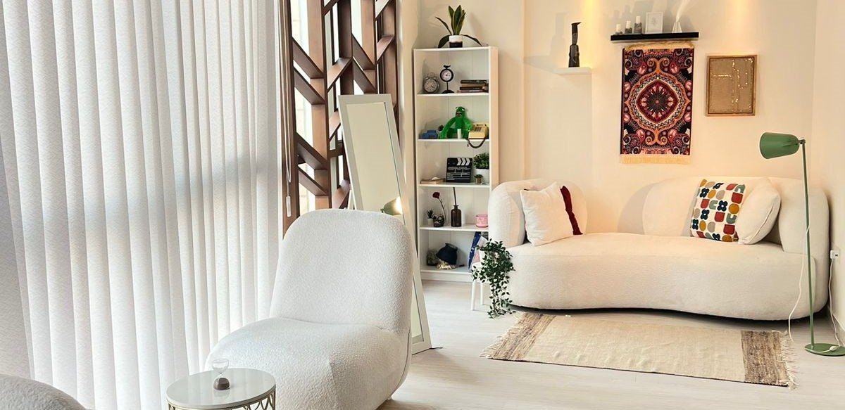 The Limitless Power studio lounge with white sofas, plants and warm light